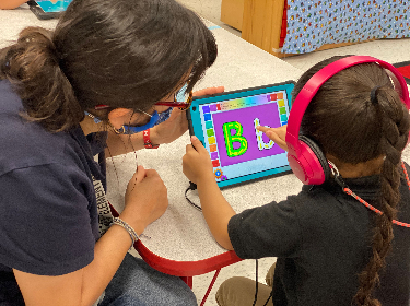 Teacher working with a student