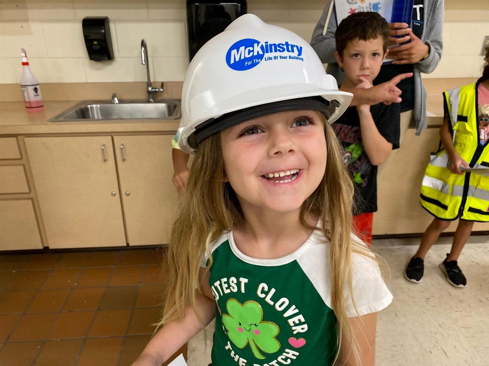 young student wearing a McKinstry hat