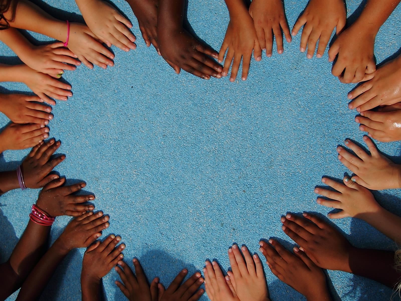  children's hands forming a heart