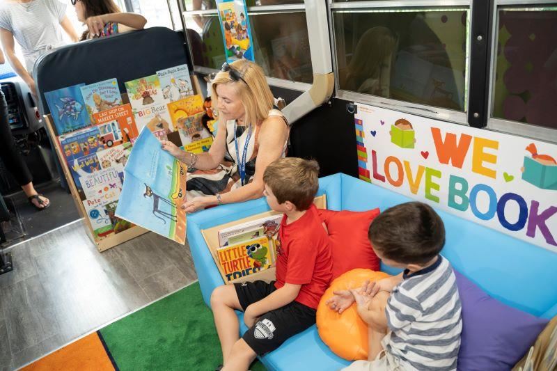 Children being read to on on Paige, the Literacy Bus